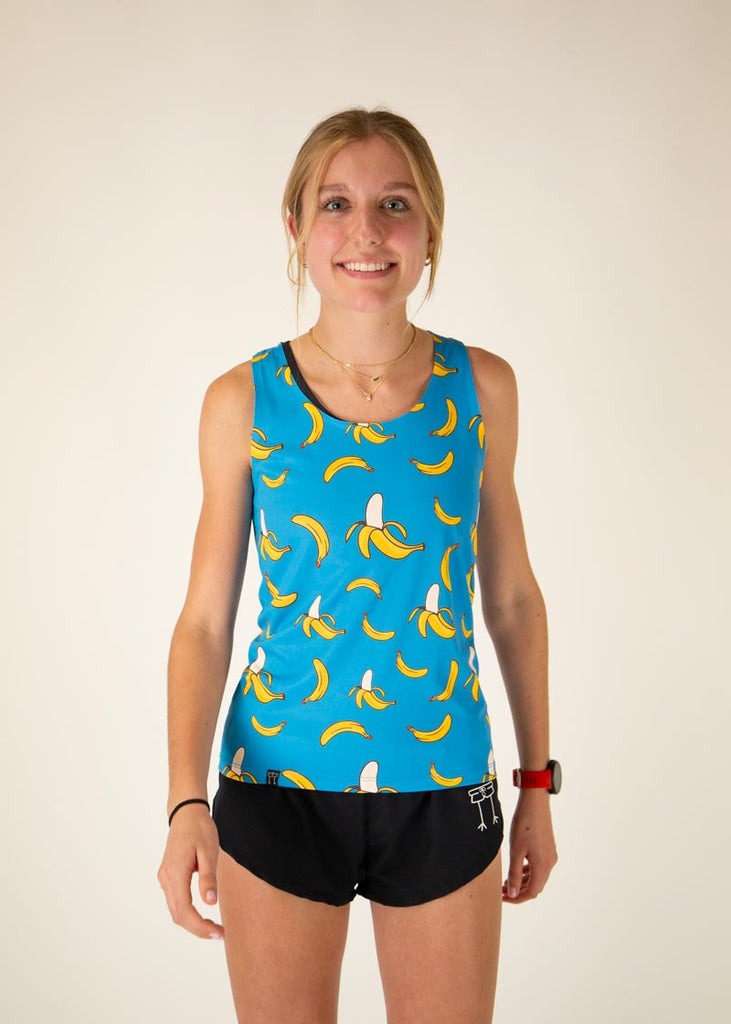 The model is a runner who is wearing Chicknlegs women's performance singlet in the blue banana design, facing front.