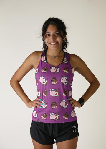 Model wearing Chicknlegs women's performance singlet in the choccy cow design front view.