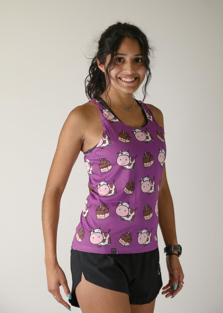 Model wearing Chicknlegs women's performance singlet in the choccy cow design right side view.