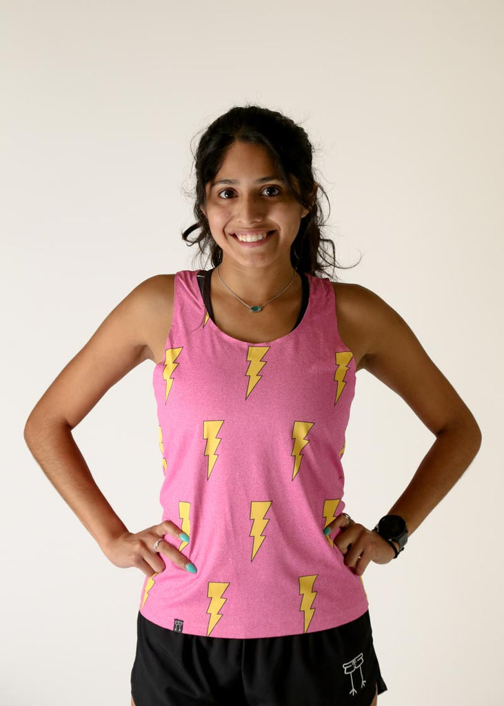 Model wearing Chicknlegs women's performance singlet in the hot pink bolts design front view.