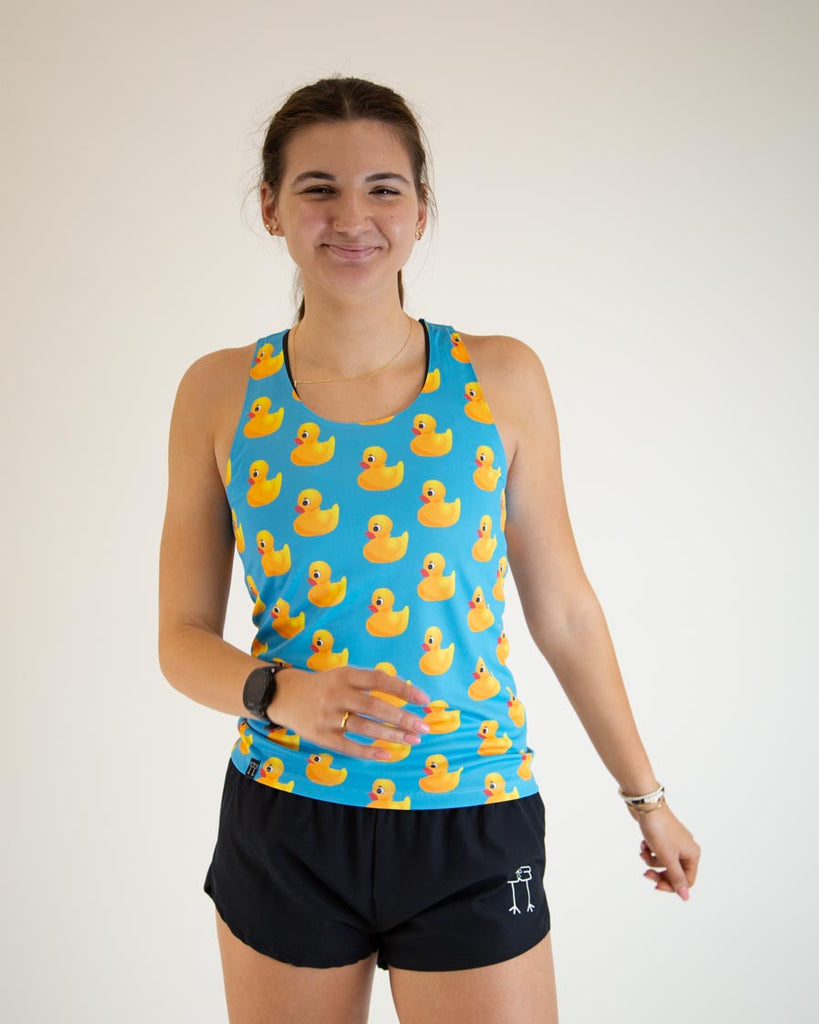 Runner is wearing ChicknLegs women's performance singlet in the rubber ducky design. The print has yellow ducks on it.