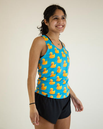 Runner is wearing ChicknLegs in the men's performance rubber ducky singlet. The print has yellow rubber ducks on it with a blue background. 