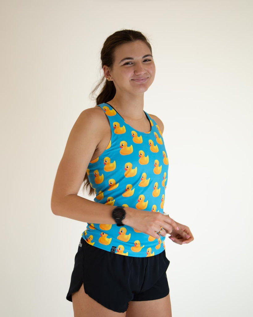 Runner is wearing ChicknLegs women's performance singlet in the rubber ducky design.