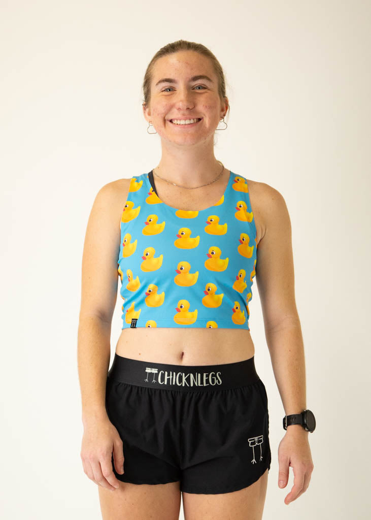 The model is a runner who is wearing Chicknlegs PWR crop top, in the rubber ducky design, facing front.