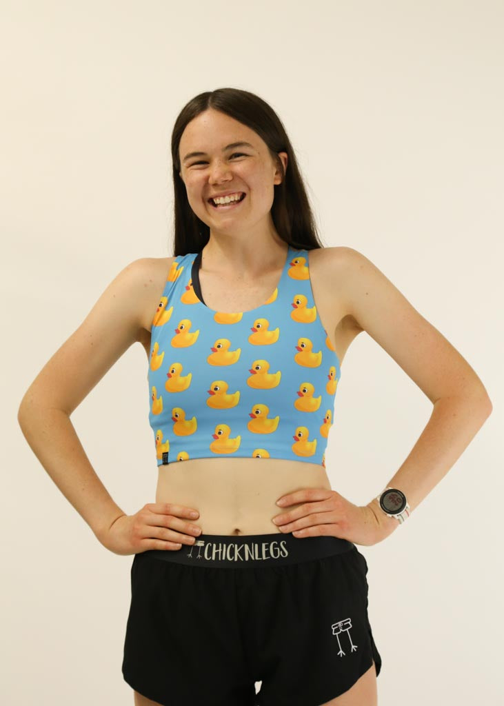 Front view of runner wearing the women's rubber ducky PWR crop top from ChicknLegs.