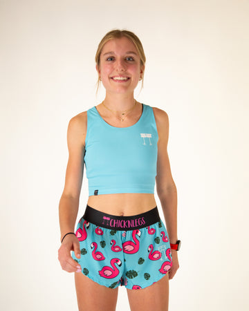 Runner is wearing ChicknLegs in women's power crop top in the sky blue design. The material is lightweight and the print is the solid blue color that matches with the blue flamingo design.