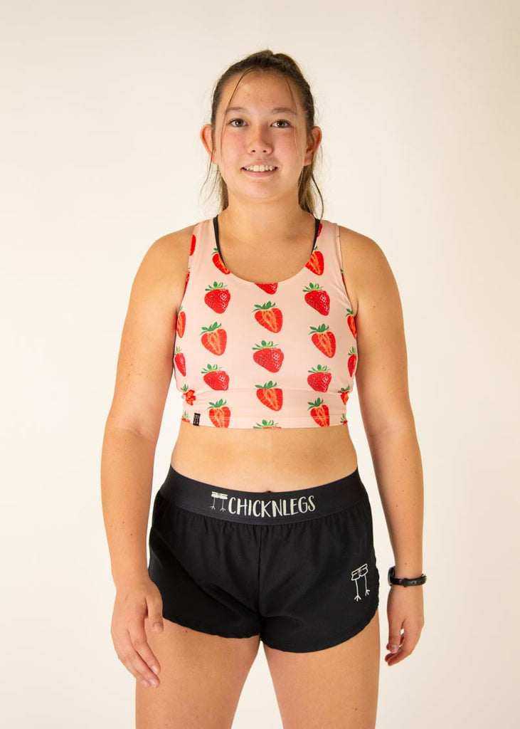 The model is wearing Chicknlegs women's pwr crop top in the strawberry szn design, facing front.