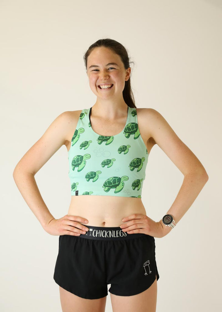 Front view of runner wearing the Women's Sea Turtles PWR Crop Top from ChicknLegs