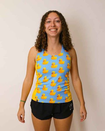 Runner is wearing ChicknLegs in the women's performance side panel singlet in the rubber ducky design. The sides are bright yellow with a light blue background.