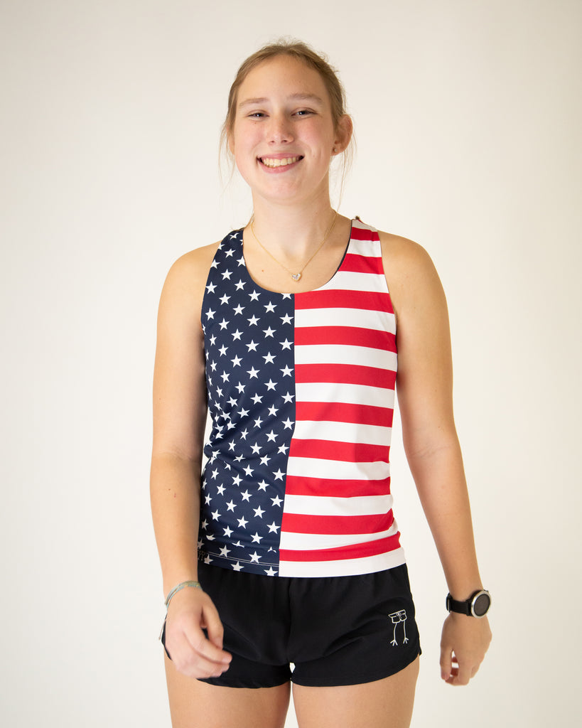 Runner is wearing ChicknLegs in the women's USA State Flag design, as a performance singlet. Great for runners who love America.