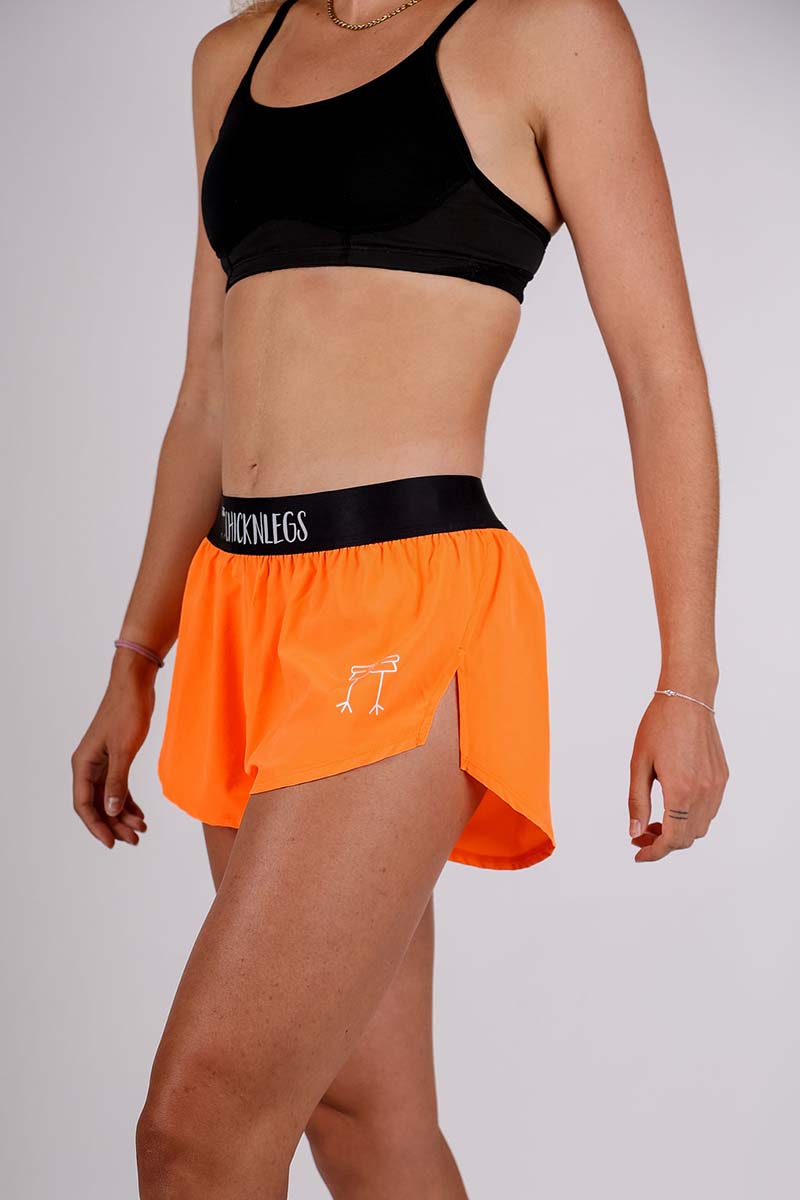 https://www.chicknlegs.com/cdn/shop/products/chicknlegs-womens-neon-orange-running-shorts-side-logo.jpg?v=1655483717&width=1445